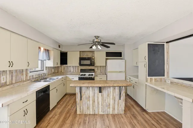 a kitchen with stainless steel appliances a sink stove and cabinets