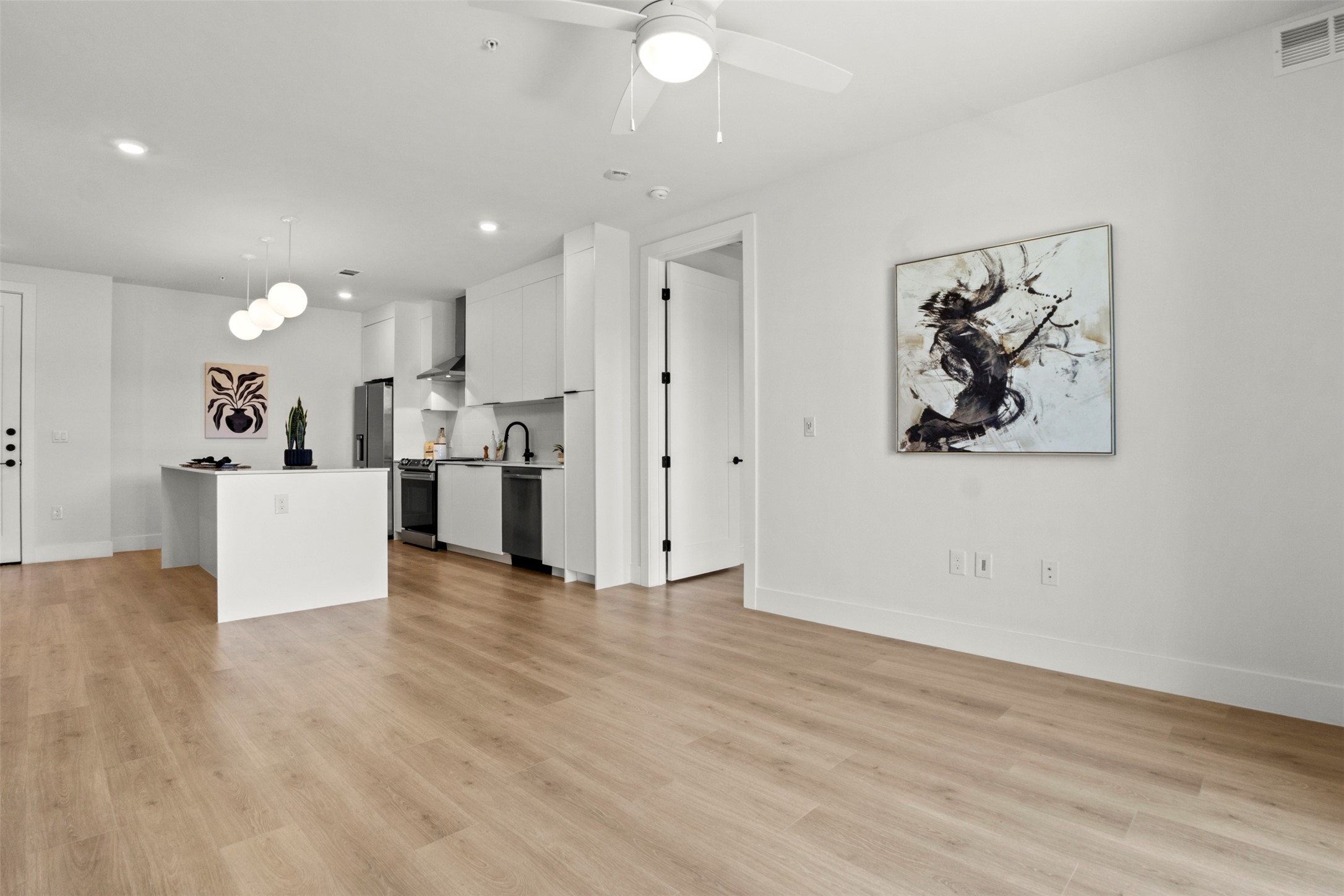 1701 Simond Avenue, Unit 418 Austin, TX 78723 - Photo 10 of 37 Living room featuring light wood-style floors, recessed lighting.