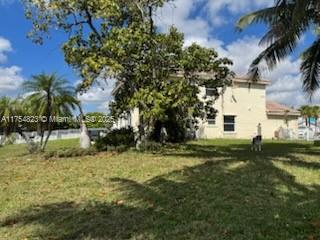 Silver Lakes Miramar, FL 33029 - Photo 6 of 12 a view of backyard of house with green space