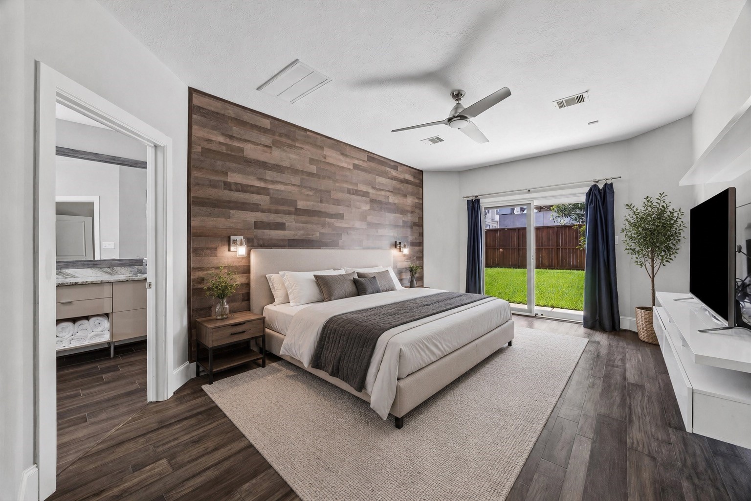 14855 Perthshire Road Houston, TX 77079 - Photo 4 of 43 First floor primary suite with wood accent wall. Virtually enhanced.