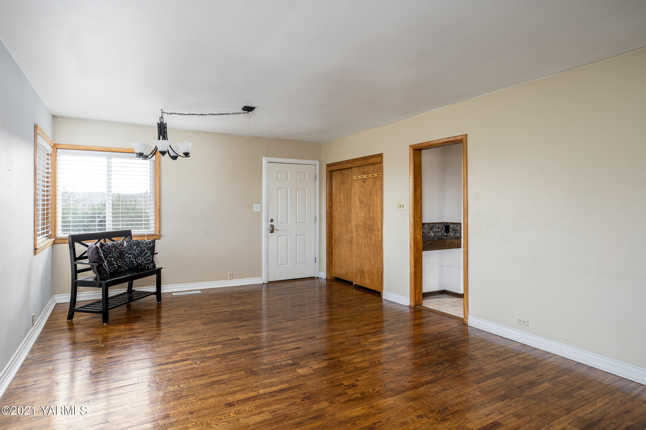 9380 Lateral A Road Wapato, WA 98951 - Photo 8 of 40 a view of an empty room with wooden floor and a window