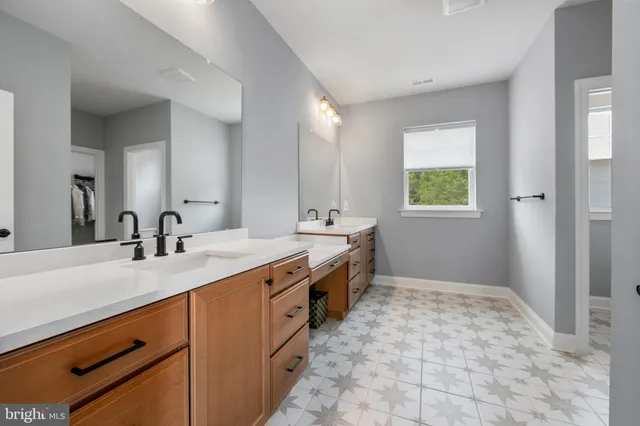 a spacious bathroom with a granite countertop sink a mirror and a