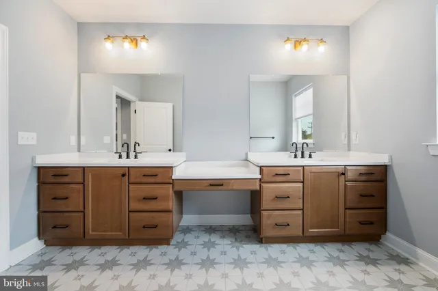 a bathroom with a granite countertop sink and mirror