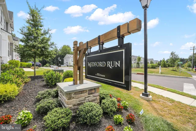 a sign board with a street sign on the side of the road