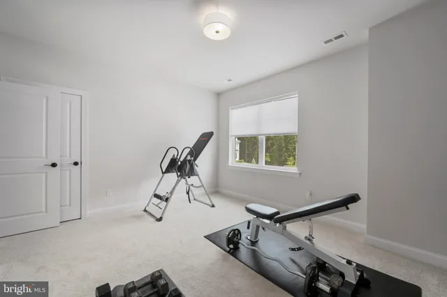 a room with gym equipment and windows