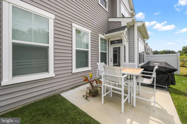 a view of a patio with table and chairs and potted plants