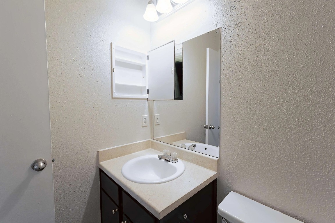 2809 West William Cannon Drive, Unit I101 Austin, TX 78745 - Photo 14 of 29 a bathroom with a sink and a toilet