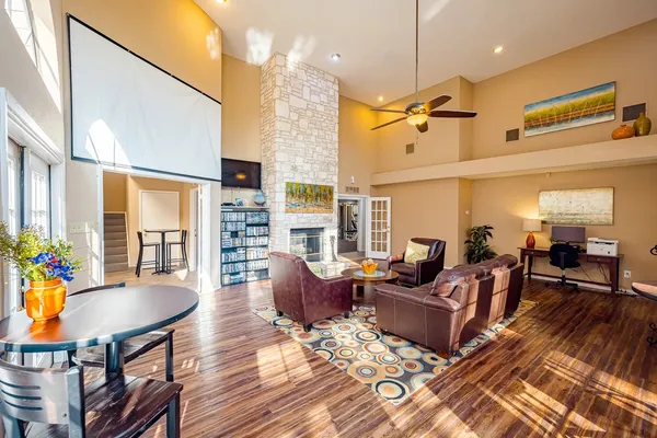 a living room with fireplace furniture and a wooden floor