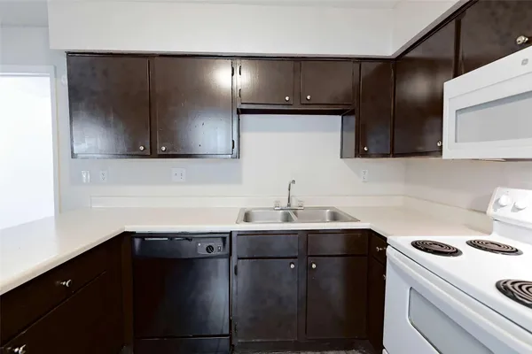 a kitchen with a sink and a stove