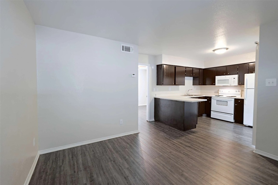 2809 West William Cannon Drive, Unit I101 Austin, TX 78745 - Photo 7 of 29 a view of kitchen with wooden floor