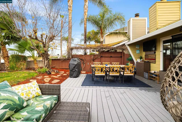 a balcony with wooden floor and city view