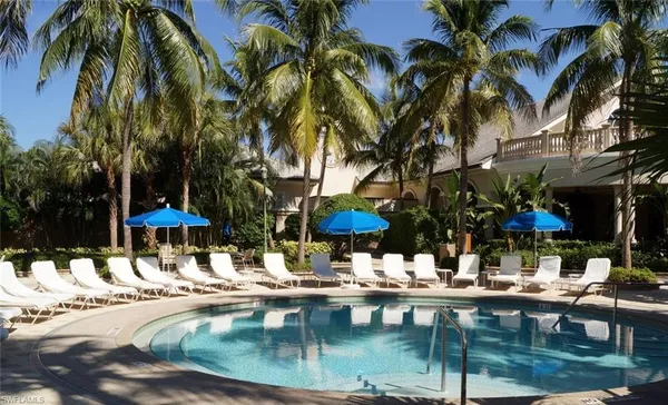 a swimming pool with outdoor seating and yard