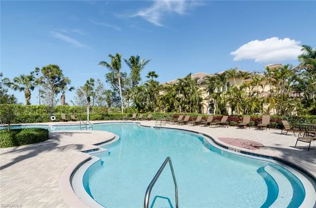 a view of a swimming pool and lounge chair
