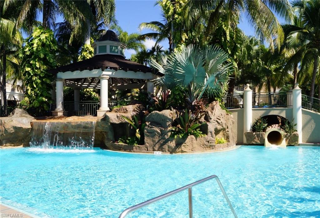 4650 Hawks Nest Way, Unit M202 Naples, FL 34114 - Photo 16 of 19 a view of a chair and tables in the yard