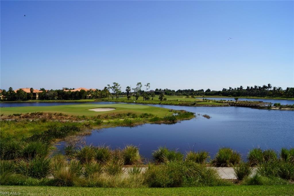 4650 Hawks Nest Way, Unit M202 Naples, FL 34114 - Photo 18 of 19 a view of a lake with a city view