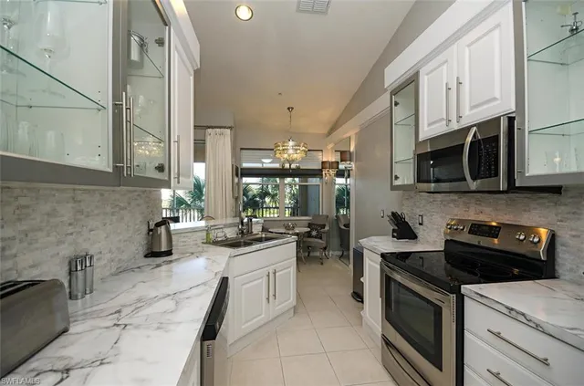 a kitchen with stainless steel appliances a sink stove and cabinets