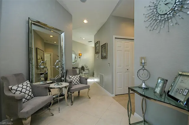 a living room with furniture a lamp and a potted plant