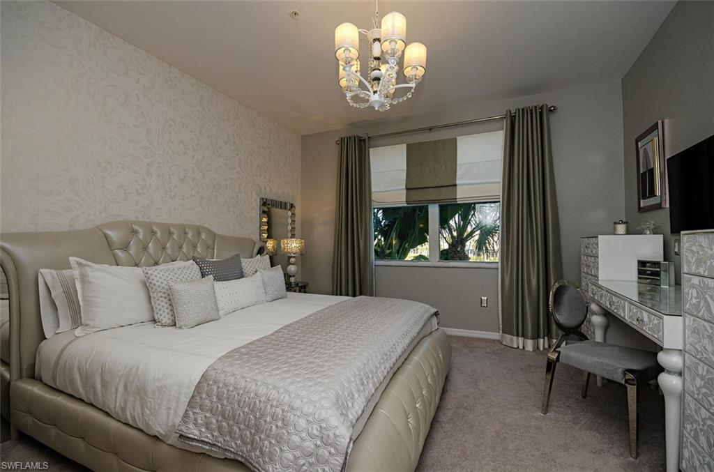 4650 Hawks Nest Way, Unit M202 Naples, FL 34114 - Photo 5 of 19 a bedroom with bed tv and window