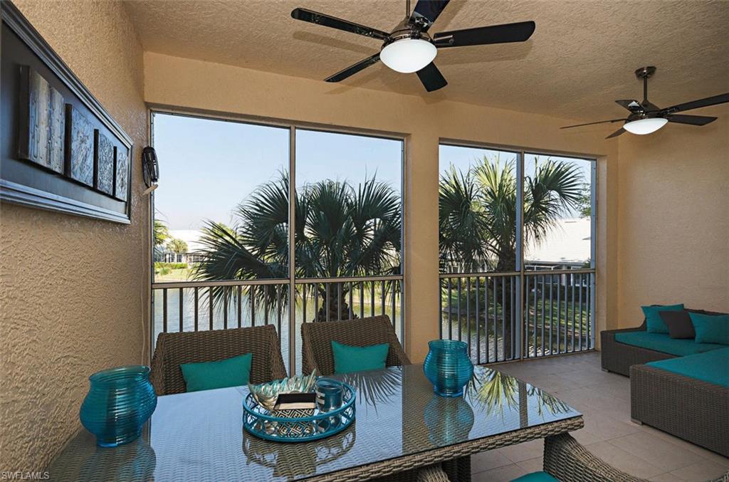 4650 Hawks Nest Way, Unit M202 Naples, FL 34114 - Photo 6 of 19 a living room with furniture and a floor to ceiling window