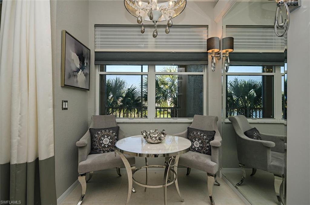 4650 Hawks Nest Way, Unit M202 Naples, FL 34114 - Photo 7 of 19 a view of a dining room with furniture window and outside view