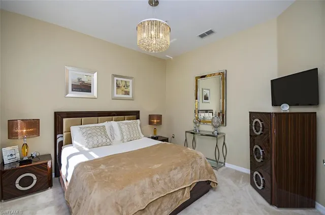 a bedroom with a bed and a television in it