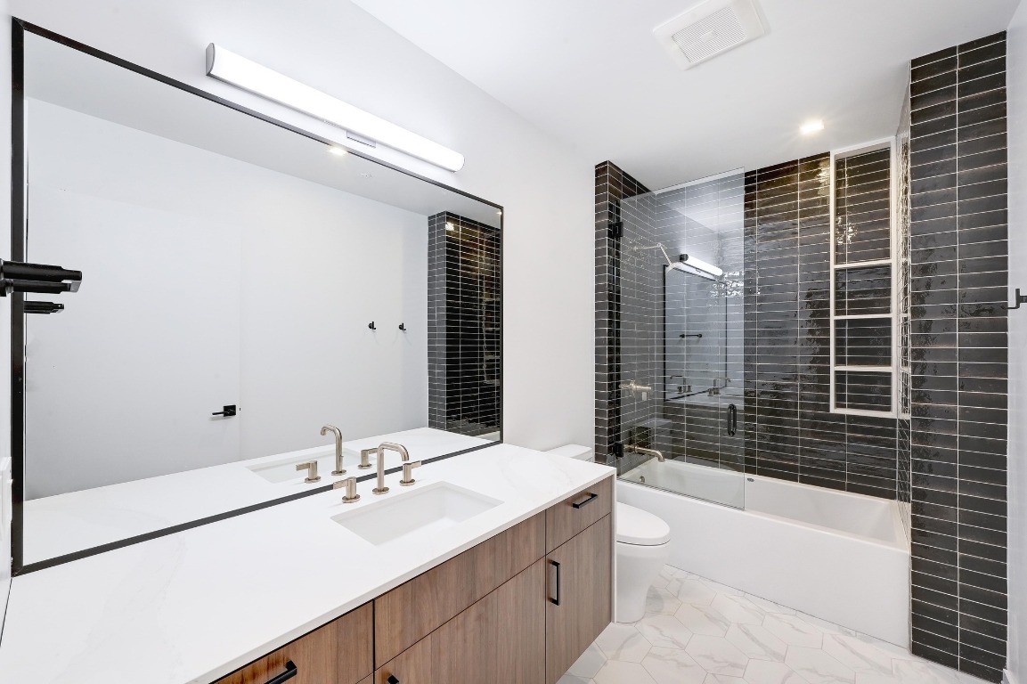 1006 Baylor Street, Unit 202 Austin, TX 78703 - Photo 12 of 23 a bathroom with a sink mirror toilet and bathtub