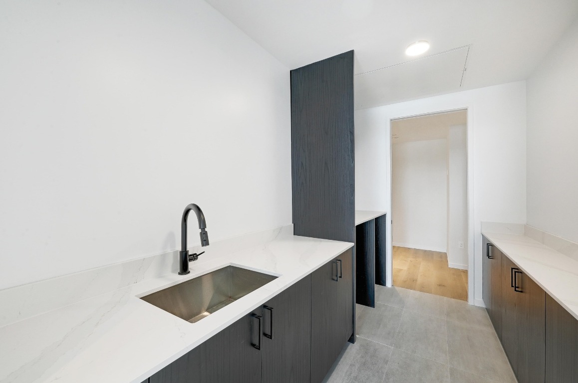 1006 Baylor Street, Unit 202 Austin, TX 78703 - Photo 18 of 23 a kitchen with a refrigerator and a sink
