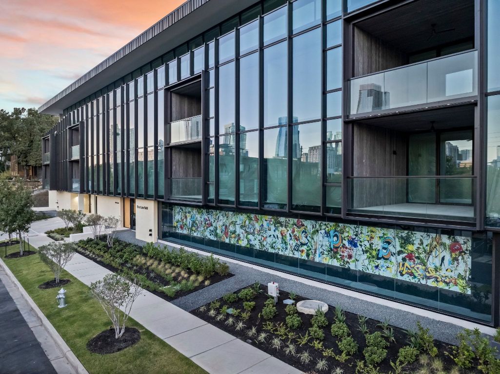 1006 Baylor Street, Unit 202 Austin, TX 78703 - Photo 22 of 23 a view of a house with a yard and wooden fence