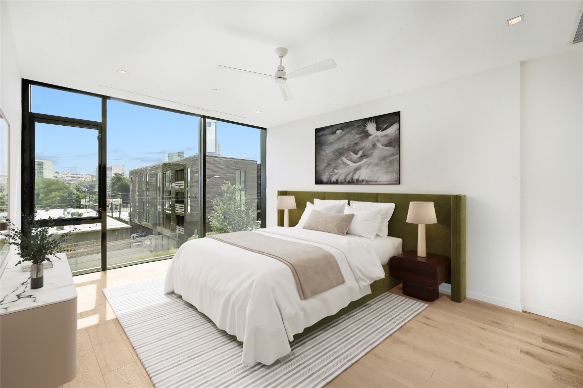 1006 Baylor Street, Unit 202 Austin, TX 78703 - Photo 9 of 23 a bedroom with a large bed and a large window