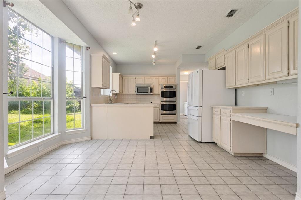 4709 Portrait Lane Plano, TX 75024 - Photo 10 of 22 Spacious kitchen with built-in desk area, and extensive storage.