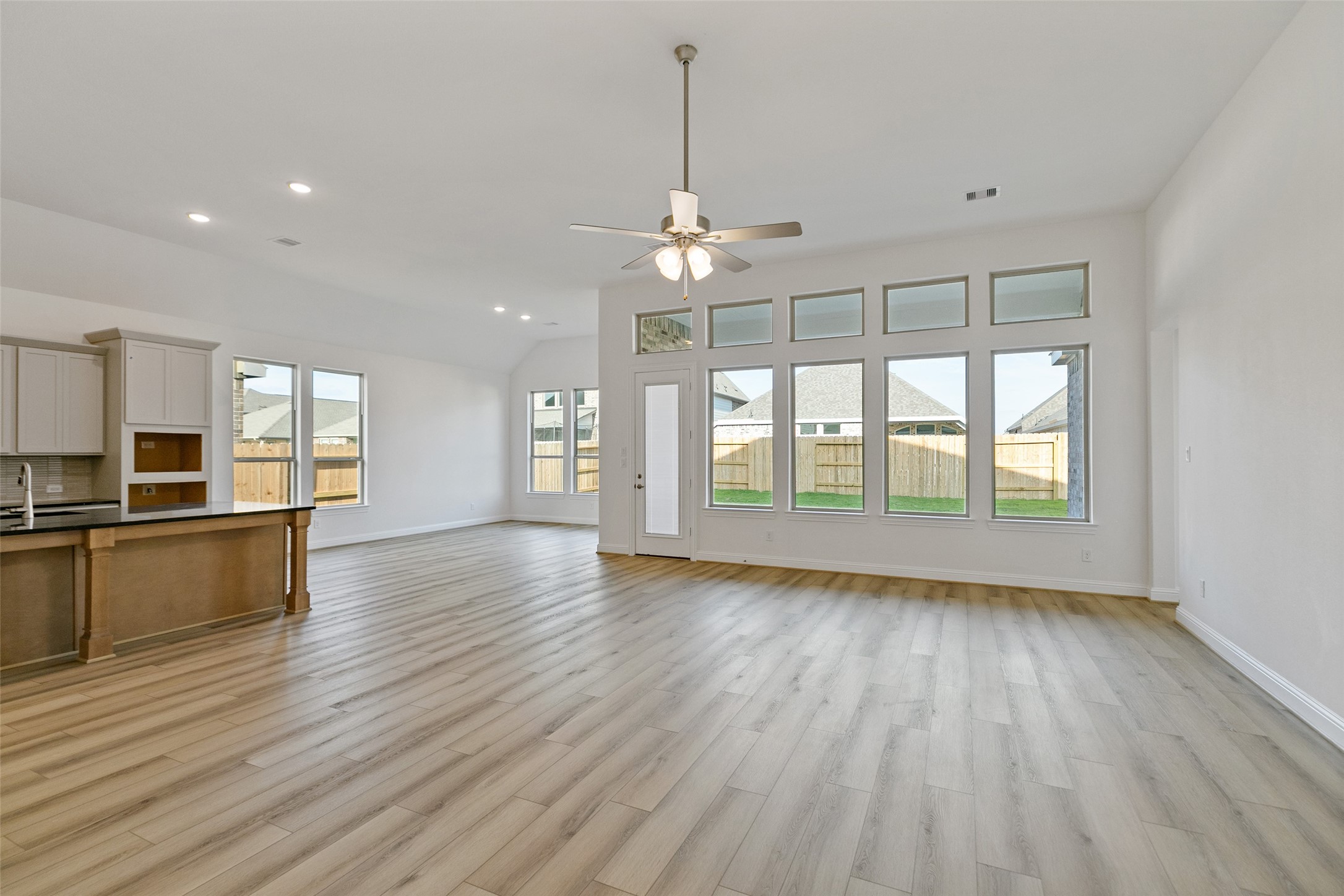 523 Blue River Trail Rosenberg, TX 77471 - Photo 13 of 34 a view of an empty room with window wooden floor and kitchen