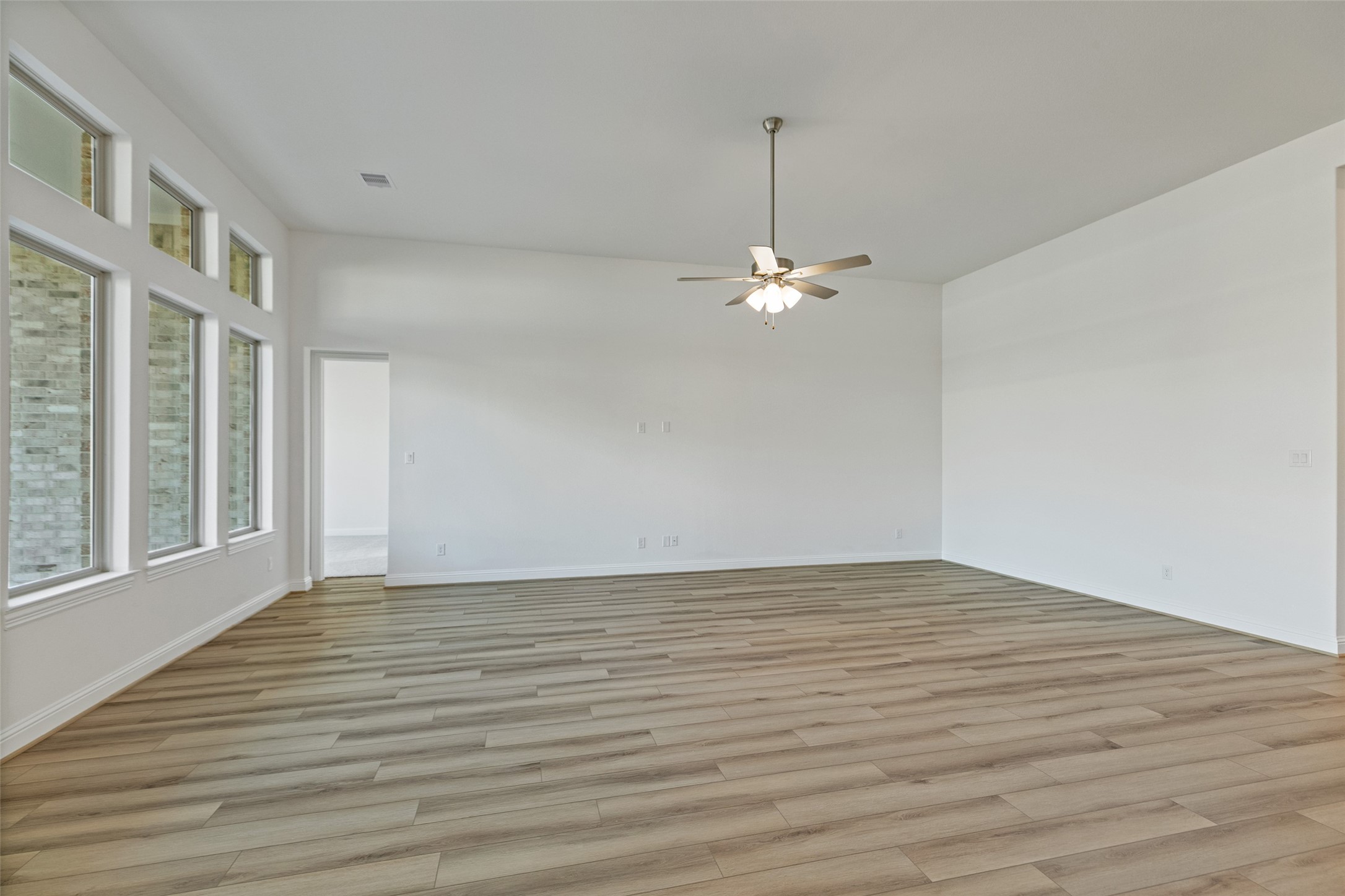 523 Blue River Trail Rosenberg, TX 77471 - Photo 15 of 34 a view of an empty room with wooden floor and a window