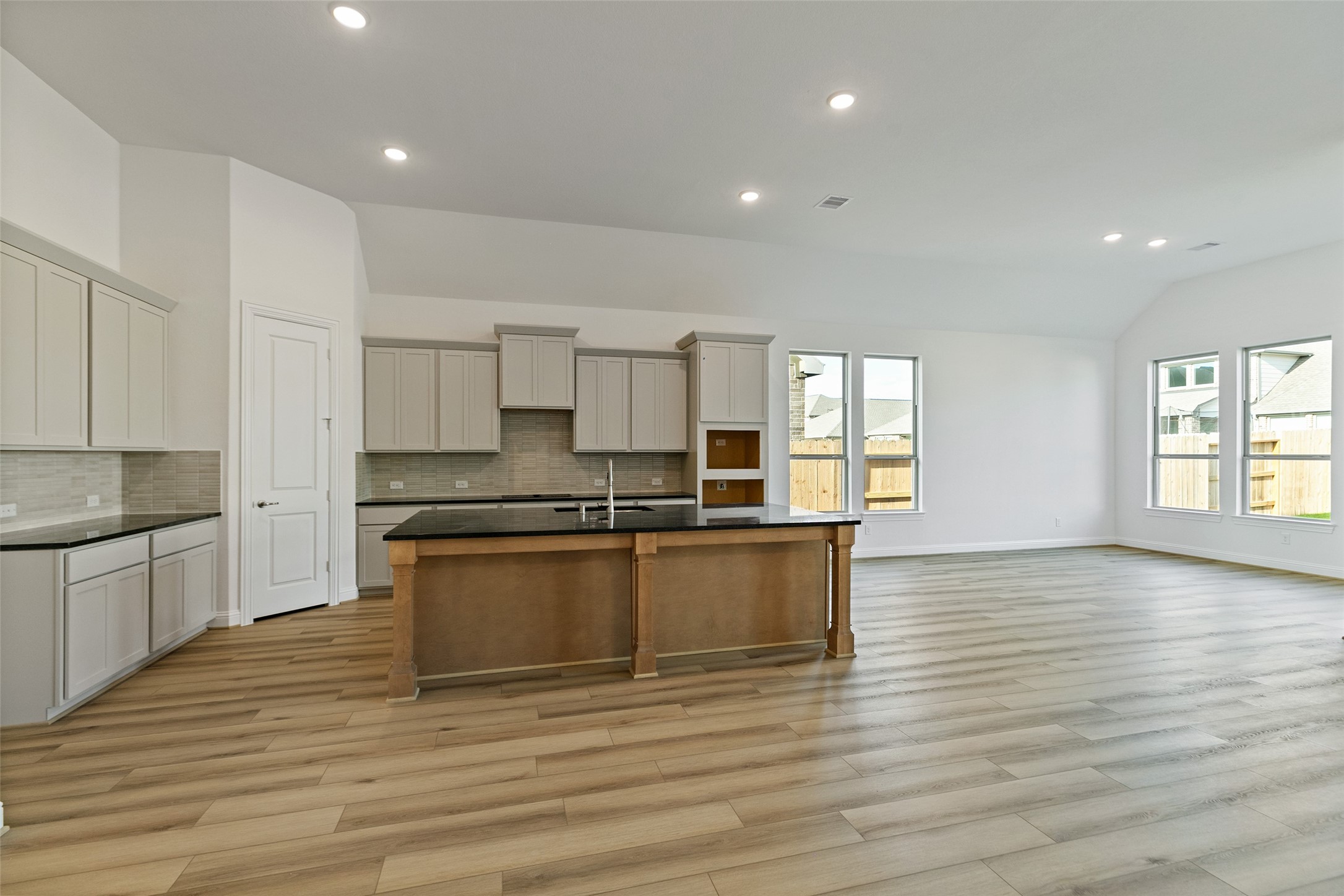 523 Blue River Trail Rosenberg, TX 77471 - Photo 16 of 34 a large kitchen with stainless steel appliances granite countertop a stove and a wooden floors