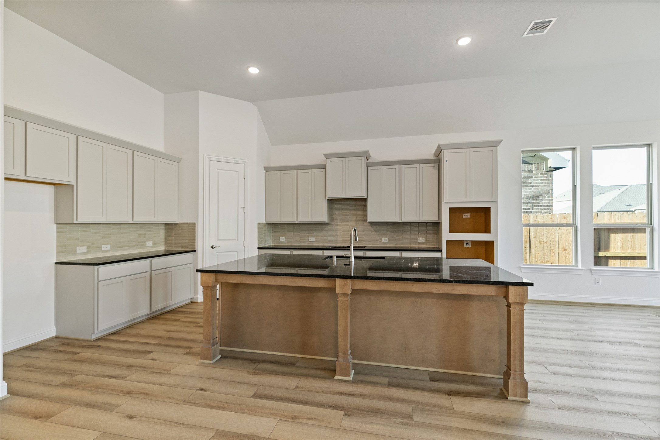 523 Blue River Trail Rosenberg, TX 77471 - Photo 17 of 34 a kitchen with stainless steel appliances granite countertop a stove a sink and a microwave