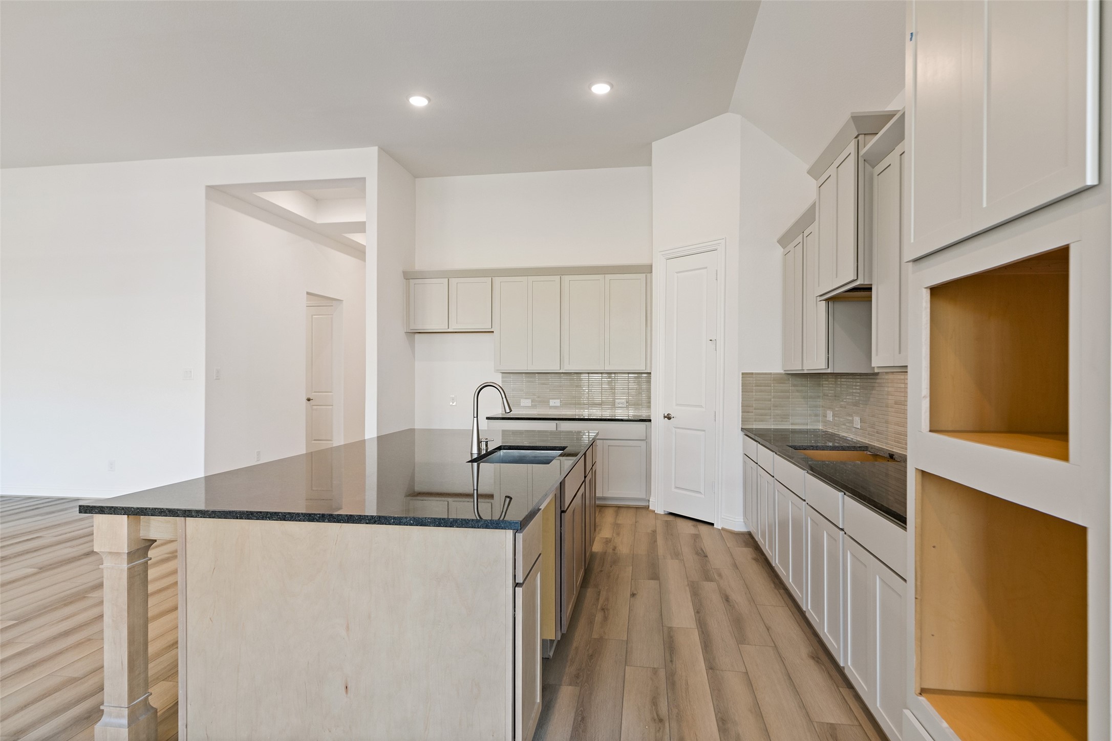 523 Blue River Trail Rosenberg, TX 77471 - Photo 21 of 34 a kitchen with stainless steel appliances granite countertop a refrigerator a stove and a sink with wooden floor