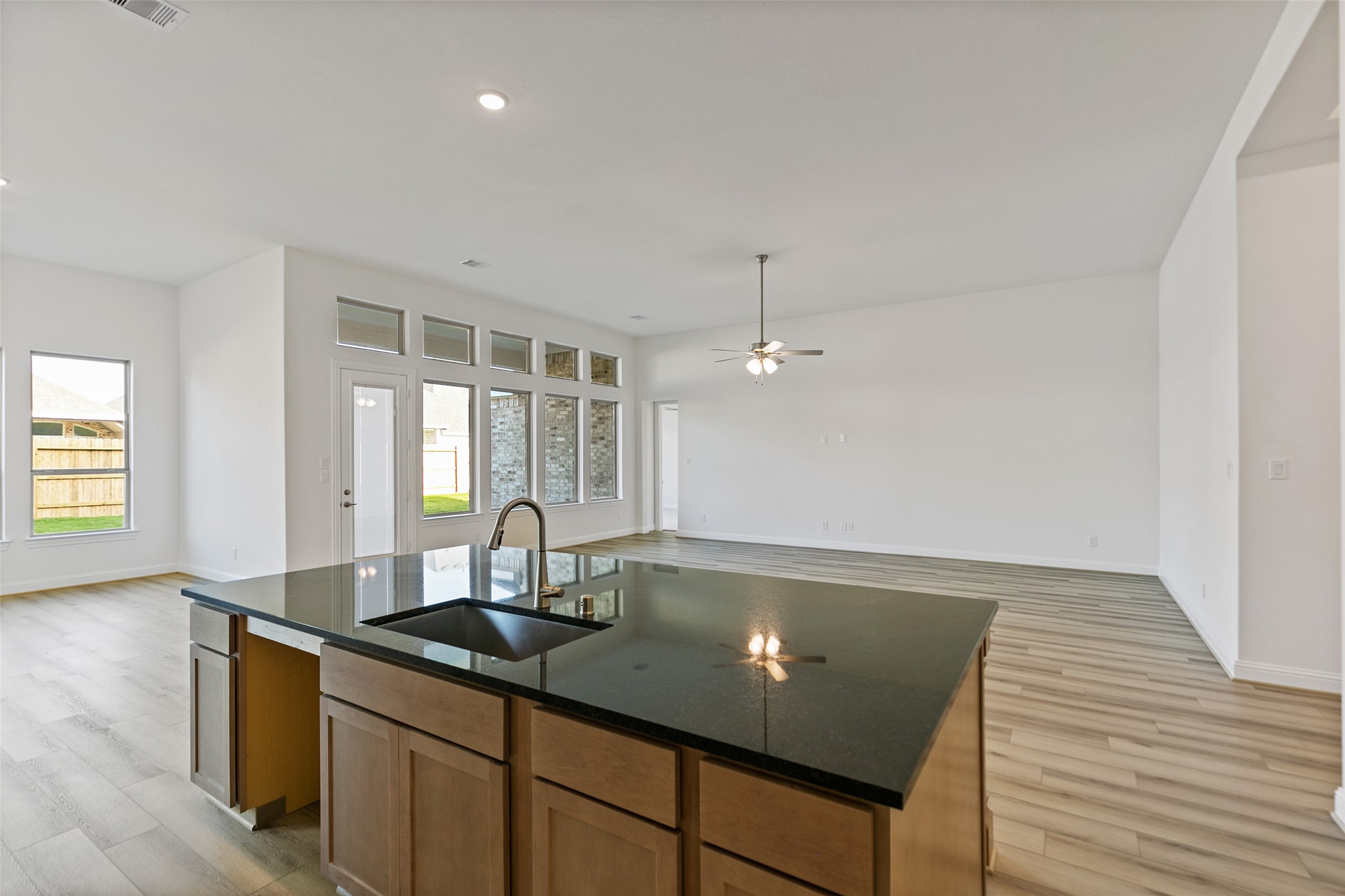 523 Blue River Trail Rosenberg, TX 77471 - Photo 22 of 34 a kitchen with granite countertop a sink and a wooden floor