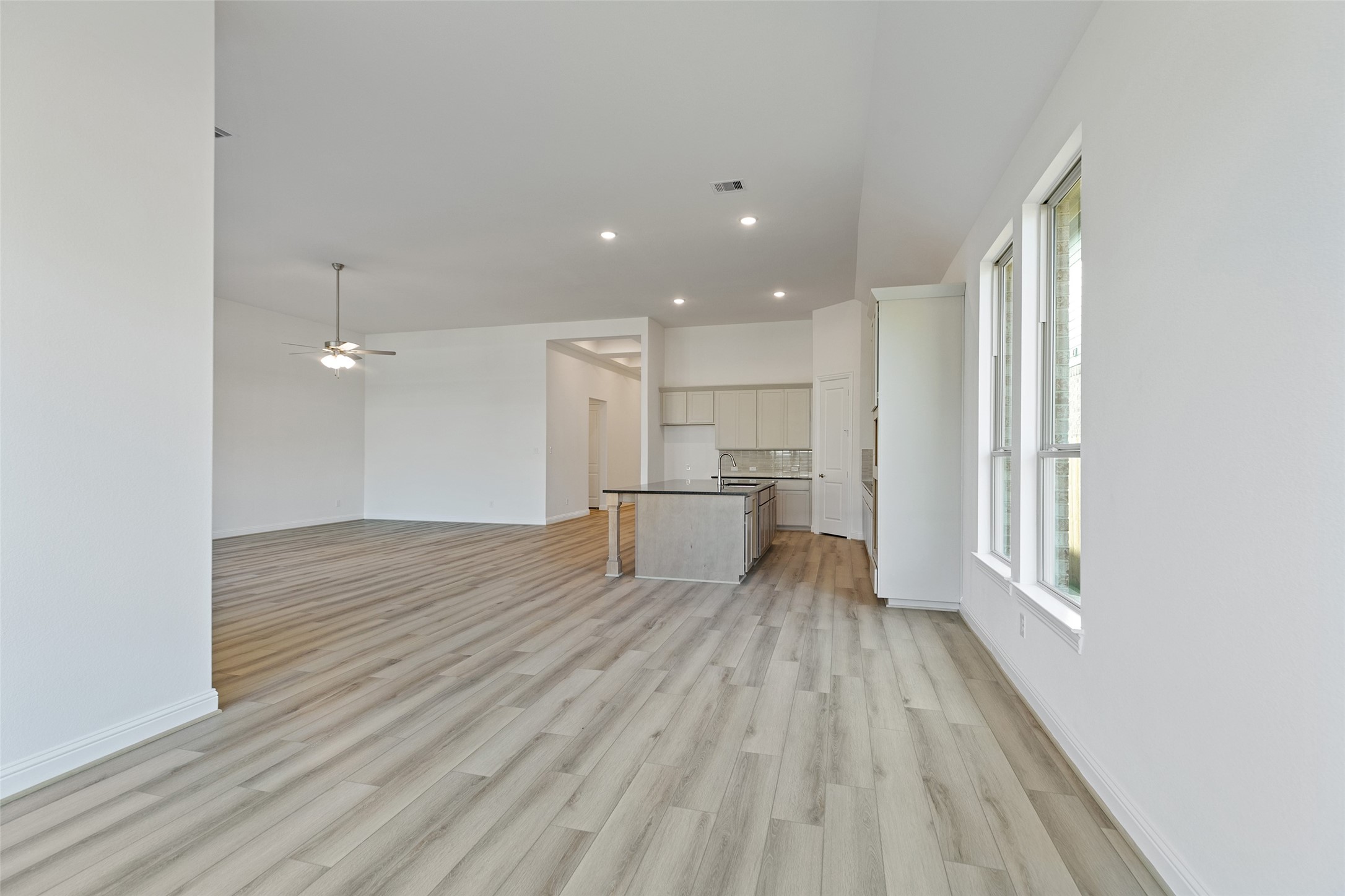 523 Blue River Trail Rosenberg, TX 77471 - Photo 24 of 34 a view of kitchen and empty room with wooden floor
