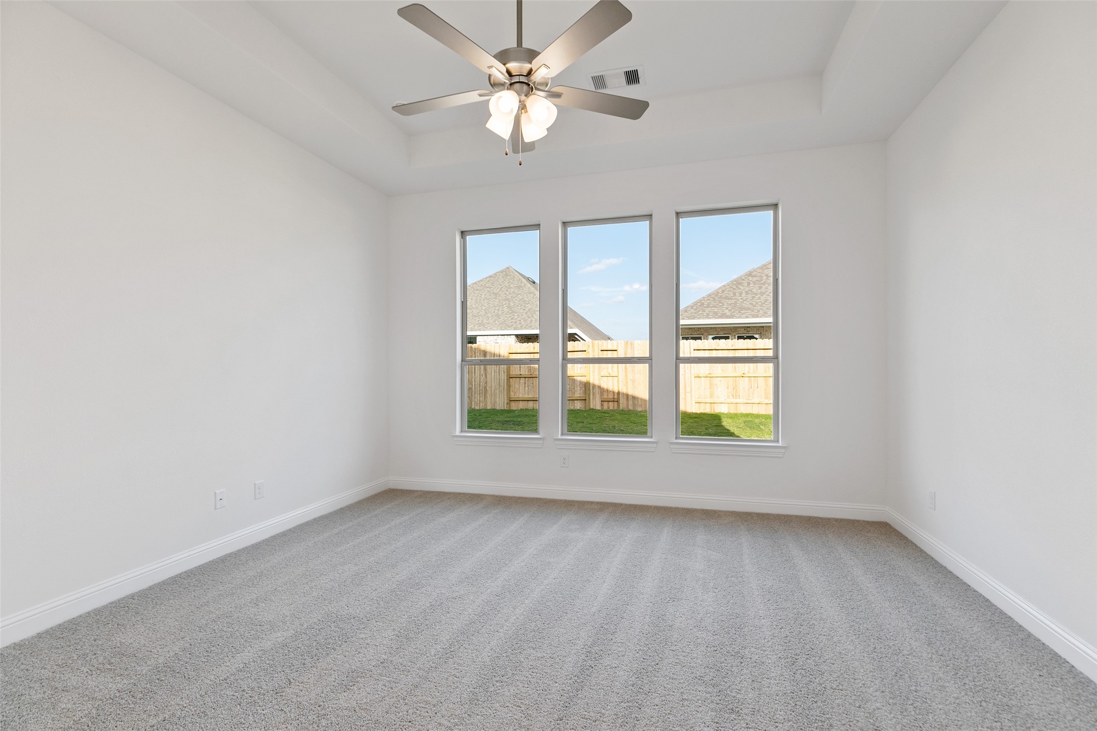 523 Blue River Trail Rosenberg, TX 77471 - Photo 25 of 34 an empty room with a window and a fan