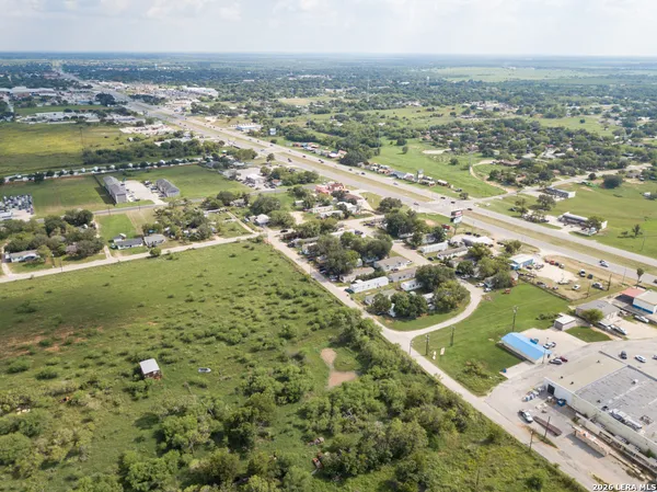 an aerial view of a residential houses with outdoor space and river