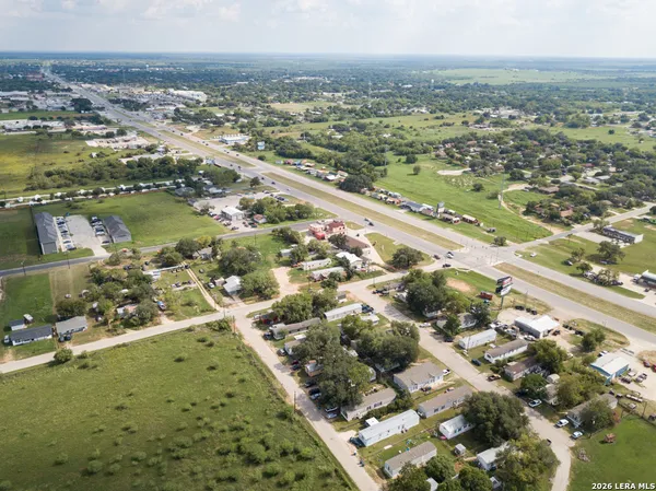 an aerial view of residential houses with outdoor space and river