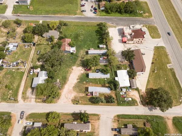 an aerial view of residential houses with outdoor space
