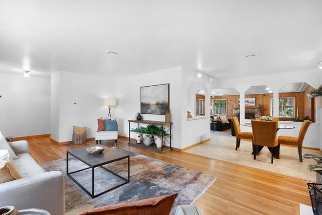 a living room with furniture a rug and a table