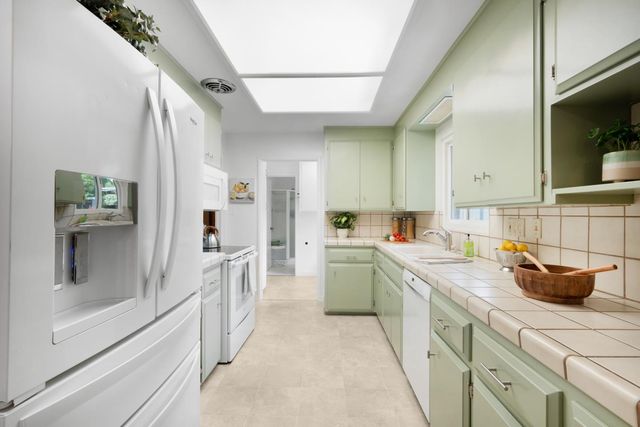 a kitchen with a sink stove and cabinets