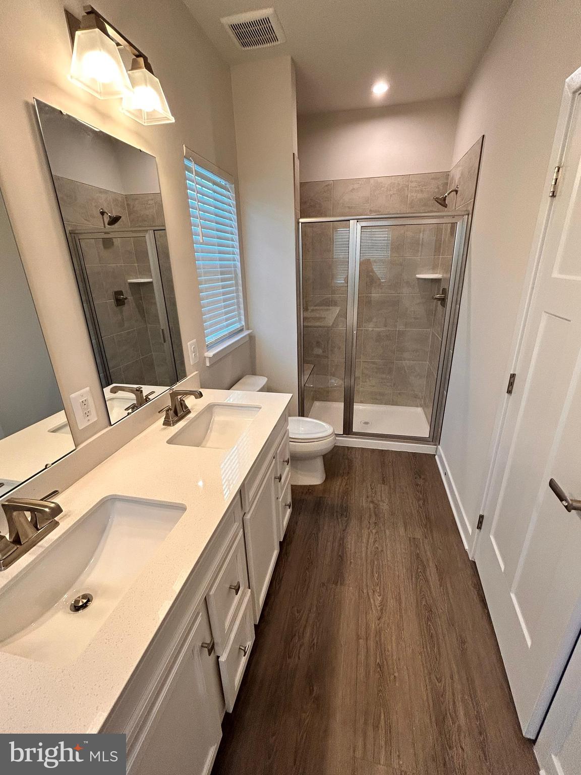 16225 Picasso Place Bowie, MD 20716 - Photo 13 of 19 a bathroom with a double vanity sink and mirror with shower