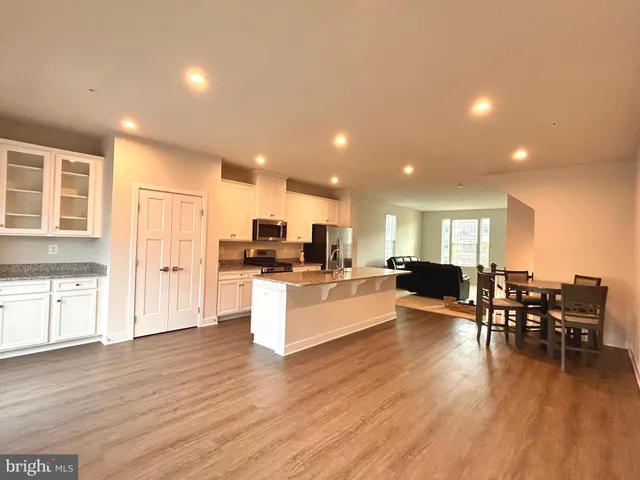 a living room with furniture and kitchen view
