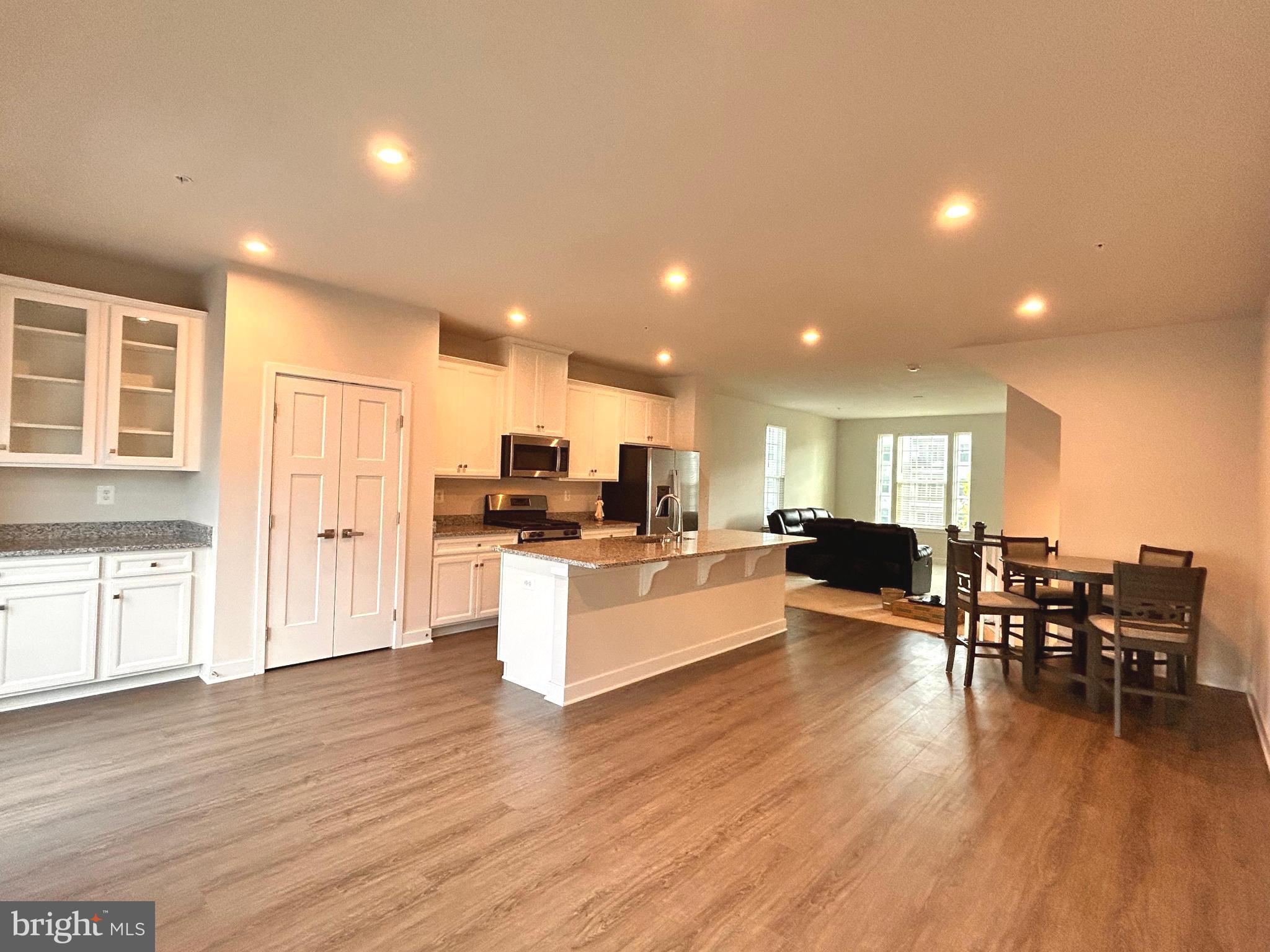 16225 Picasso Place Bowie, MD 20716 - Photo 6 of 19 a living room with furniture and kitchen view