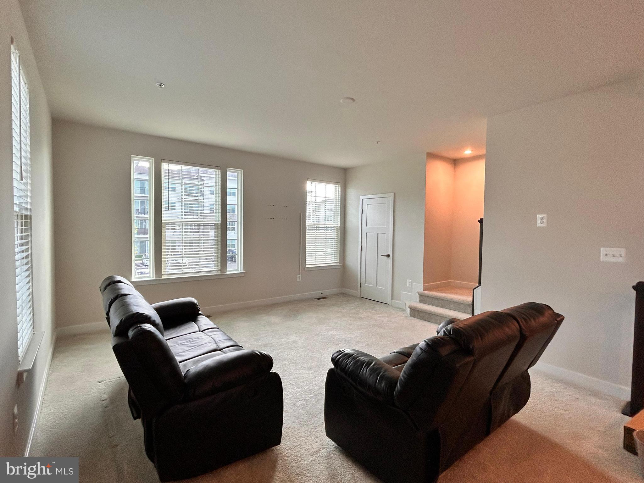 16225 Picasso Place Bowie, MD 20716 - Photo 7 of 19 a living room with furniture and a large window