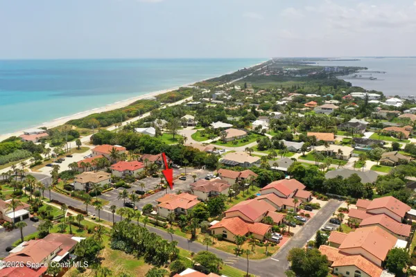 an aerial view of residential houses with outdoor space