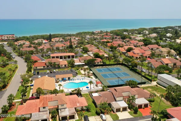 an aerial view of residential houses with outdoor space