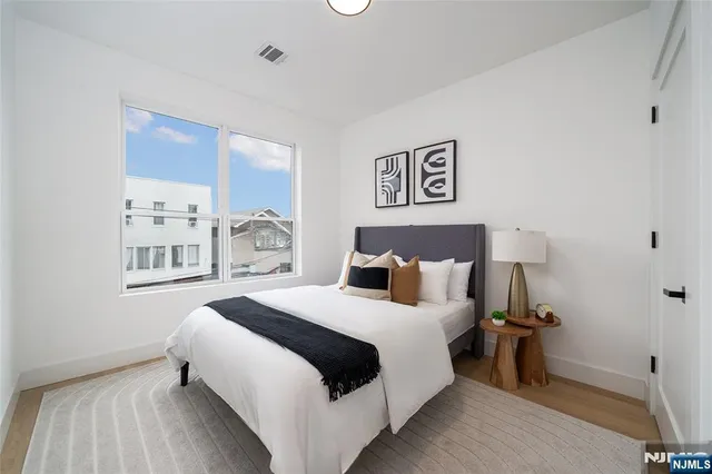 a bedroom with a bed and a night stand